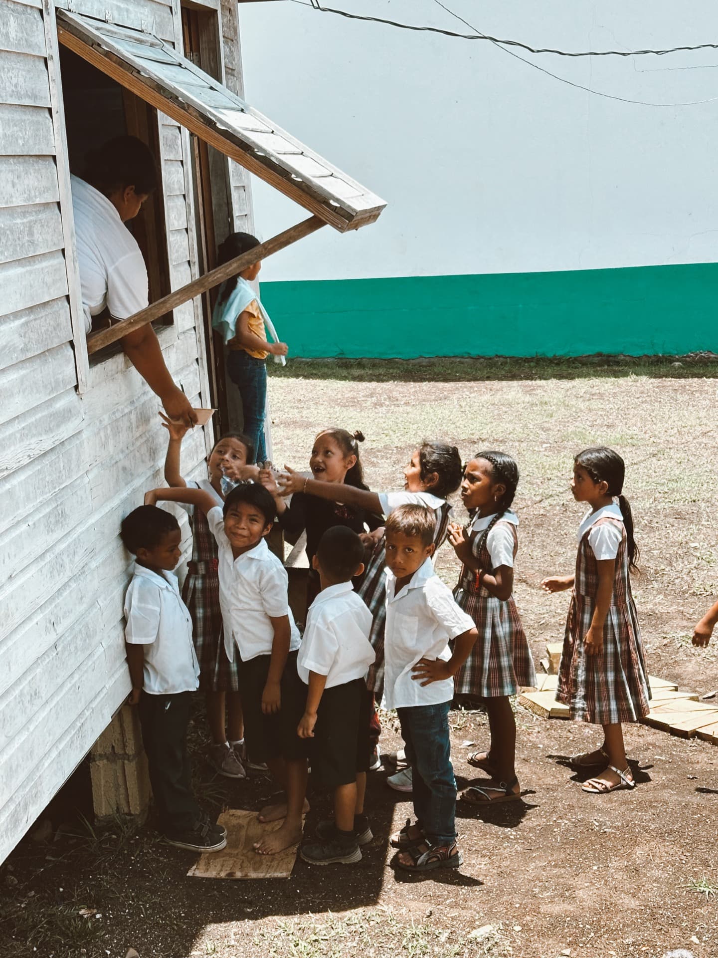 Children gathered outside a Belize school building
