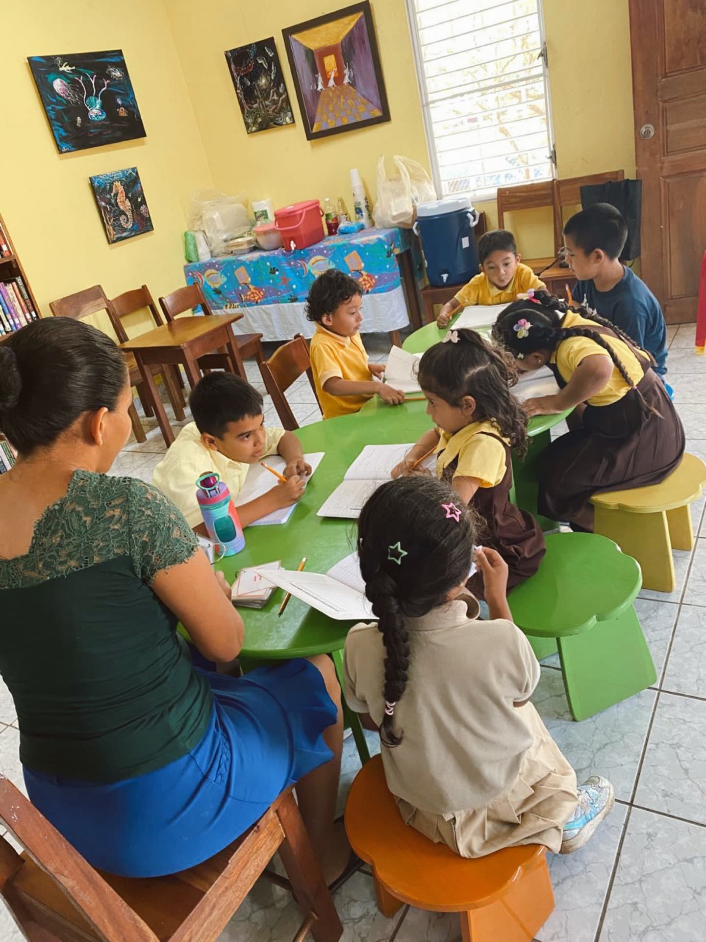 A mentor leading a small-group study session at the afterschool program
